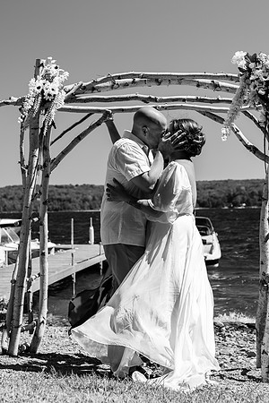 Bride walking toward lakeside ceremony on Swan Lake