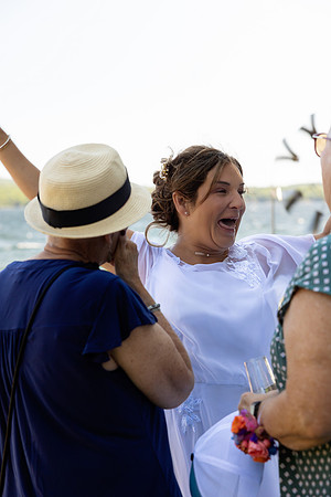 Newlyweds celebrating at lakeside wedding in Swanville Maine