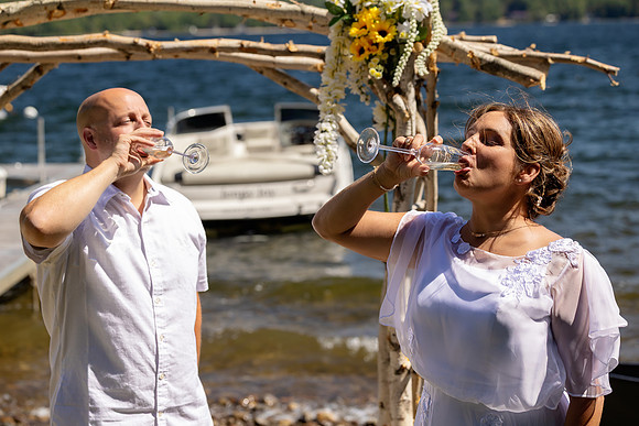 Jenny and Bracy Hood arriving by boat for their Swan Lake Maine wedding ceremony