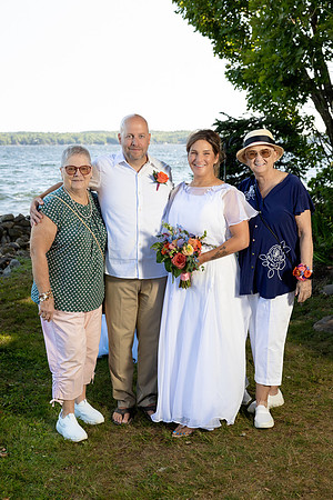 Jenny and Bracy Hood arriving by boat for their Swan Lake Maine wedding ceremony