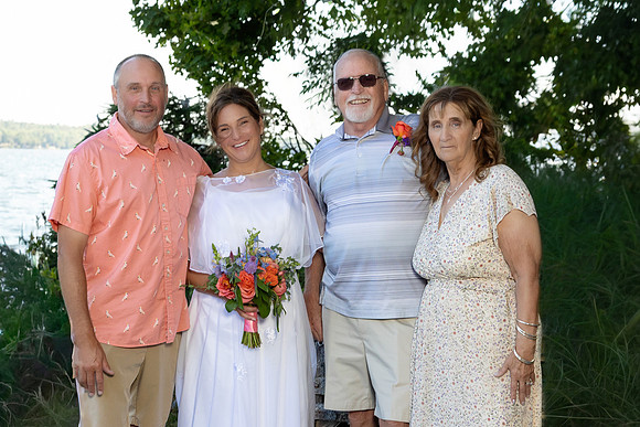 Newlyweds celebrating at lakeside wedding in Swanville Maine