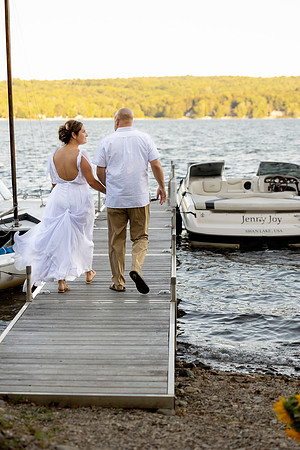 Jenny and Bracy Hood arriving by boat for their Swan Lake Maine wedding ceremony