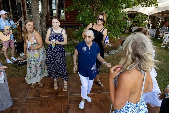 Newlyweds celebrating at lakeside wedding in Swanville Maine