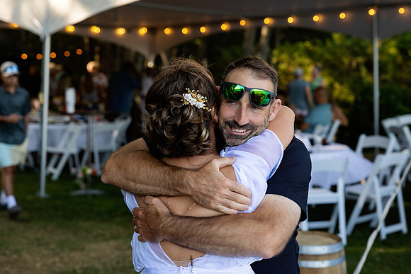 Wedding reception under tent at private waterfront home in Maine