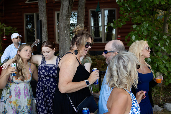 Jenny and Bracy Hood arriving by boat for their Swan Lake Maine wedding ceremony