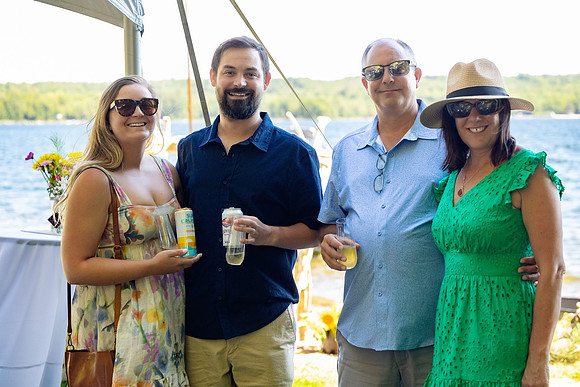 Newlyweds celebrating at lakeside wedding in Swanville Maine