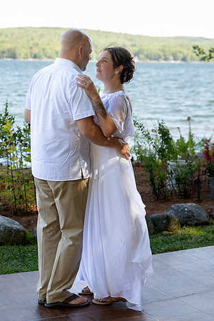 Jenny and Bracy Hood arriving by boat for their Swan Lake Maine wedding ceremony