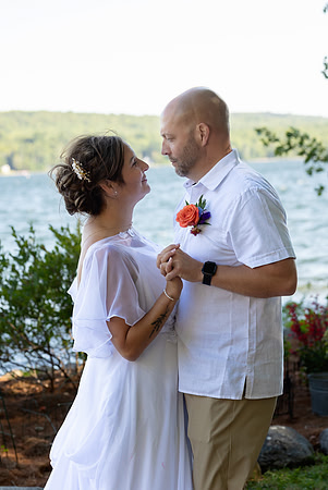 Jenny and Bracy Hood arriving by boat for their Swan Lake Maine wedding ceremony