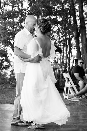 Newlyweds celebrating at lakeside wedding in Swanville Maine