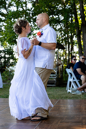 Bride walking toward lakeside ceremony on Swan Lake