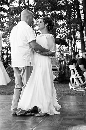 Bride walking toward lakeside ceremony on Swan Lake