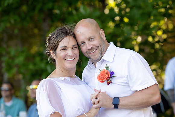 Bride and groom portrait on dock at Swan Lake Maine in August