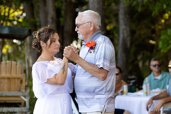 Newlyweds celebrating at lakeside wedding in Swanville Maine