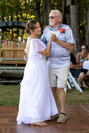 Newlyweds celebrating at lakeside wedding in Swanville Maine