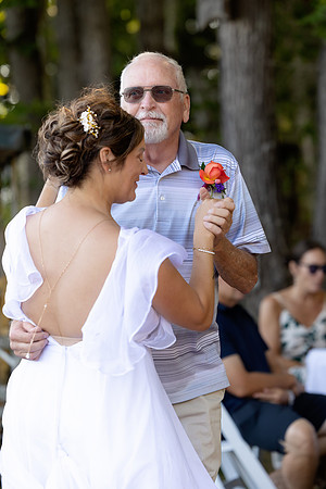 Bride walking toward lakeside ceremony on Swan Lake