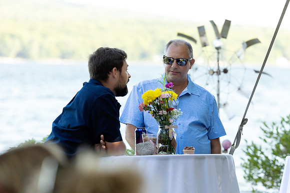 Newlyweds celebrating at lakeside wedding in Swanville Maine