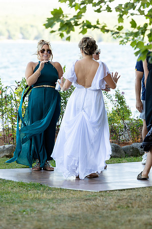 Bride walking toward lakeside ceremony on Swan Lake