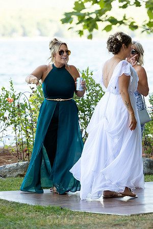 Bride walking toward lakeside ceremony on Swan Lake