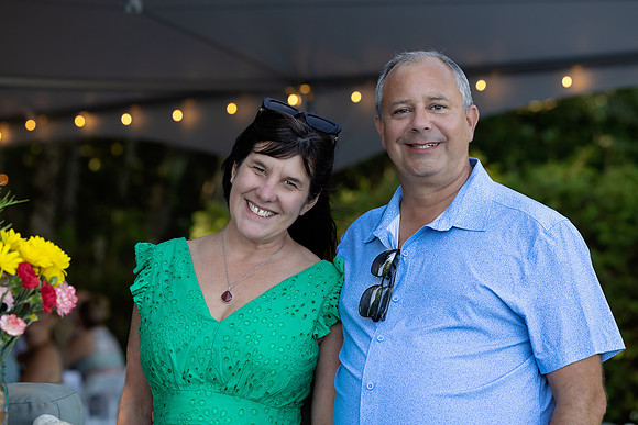 Newlyweds celebrating at lakeside wedding in Swanville Maine