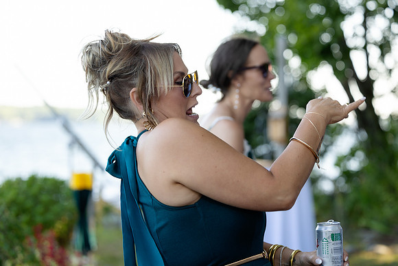 Newlyweds celebrating at lakeside wedding in Swanville Maine