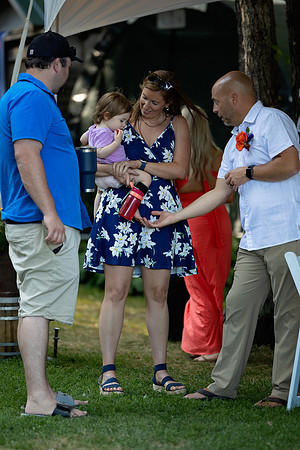 Jenny and Bracy Hood arriving by boat for their Swan Lake Maine wedding ceremony
