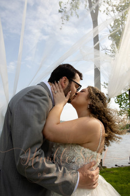 Bangor Maine wedding photography couple kissing under the veil at Grace on the Lake