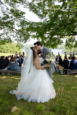 Maine wedding photography bride and groom kiss after their ceremony at Grace on the Lake