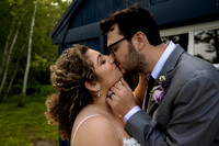 Bride and groom share a kiss during wedding portraits at Grace on the Lake