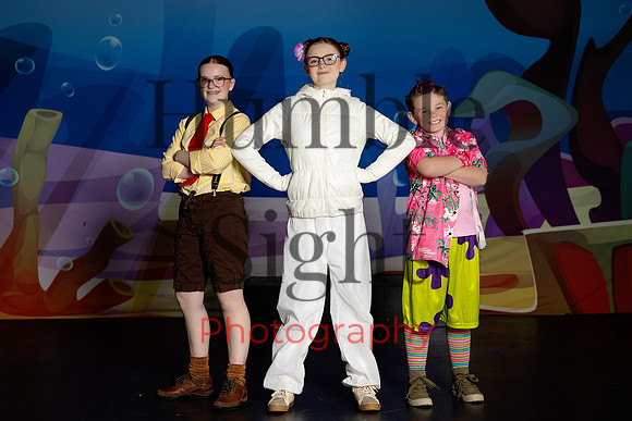 Actors in SpongeBob costumes performing on stage