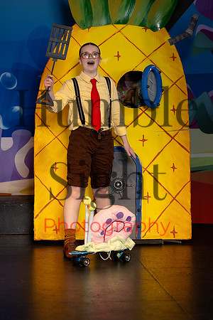 Actors in SpongeBob costumes performing on stage