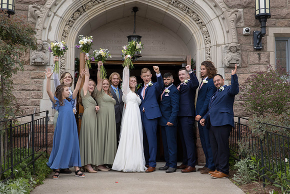 Wedding party cheering outside All Souls Congregational in Bangor, Maine after ceremony