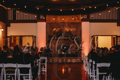 Bangor Maine wedding photography of a dark and moody indoor ceremony in front of the fireplace at Morgan Hill Event Center