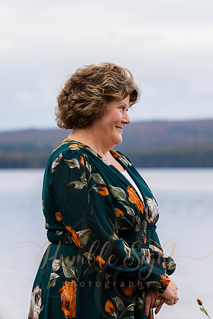 Bride and groom on dock in Maine lake wedding