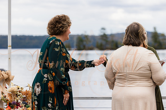 Bride and groom on dock in Maine lake wedding