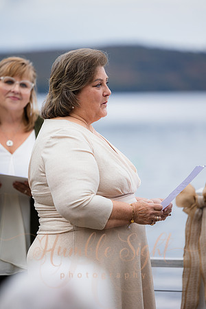 Bride and groom on dock in Maine lake wedding