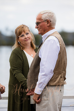 Bride and groom on dock in Maine lake wedding