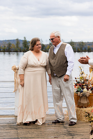 Bride and groom on dock in Maine lake wedding