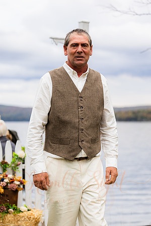 Bride and groom on dock in Maine lake wedding