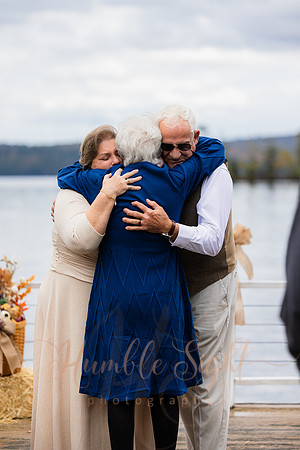 Bride and groom on dock in Maine lake wedding