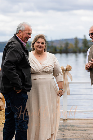 Bride and groom on dock in Maine lake wedding