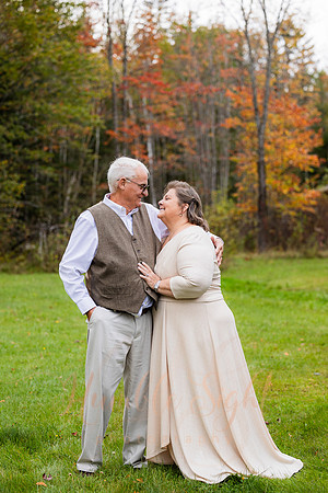 Bride and groom on dock in Maine lake wedding