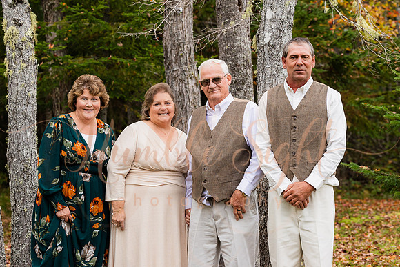 Bride and groom on dock in Maine lake wedding