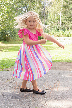 Children walking down aisle at backyard Maine wedding