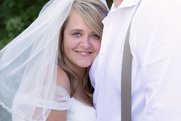 Maine bride smiling with veil backyard wedding
