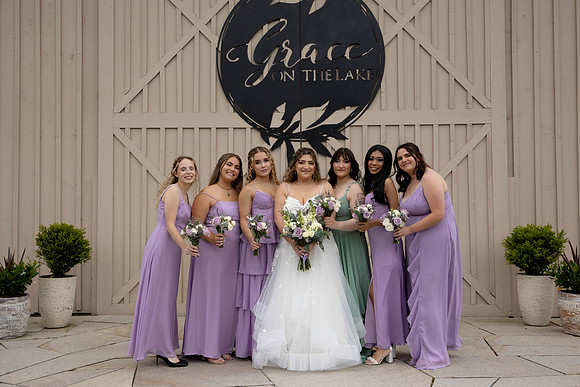 Bridesmaids and Bride pose with bouquets at Grace on the Lake