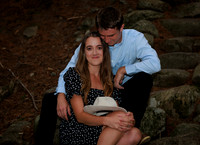 Couple walking wooded trail during Maine engagement session