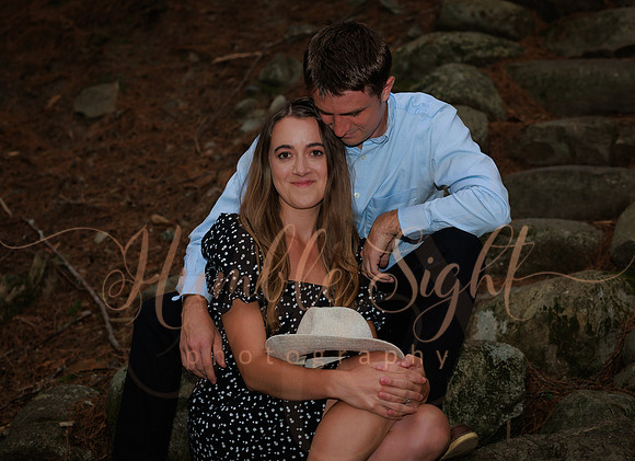Couple walking wooded trail during Maine engagement session