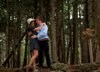 Couple walking wooded trail during Maine engagement session